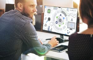 Man working on computer with grapthics shown on his screen
