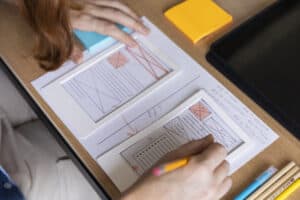 Female web designer taking notes in the office