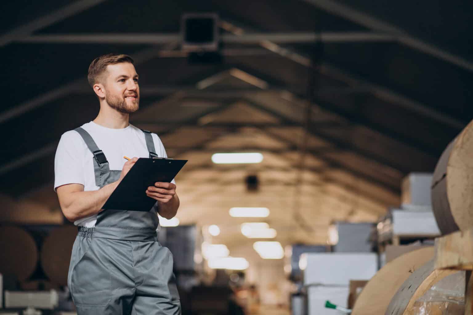 Young handsome man working at a factory