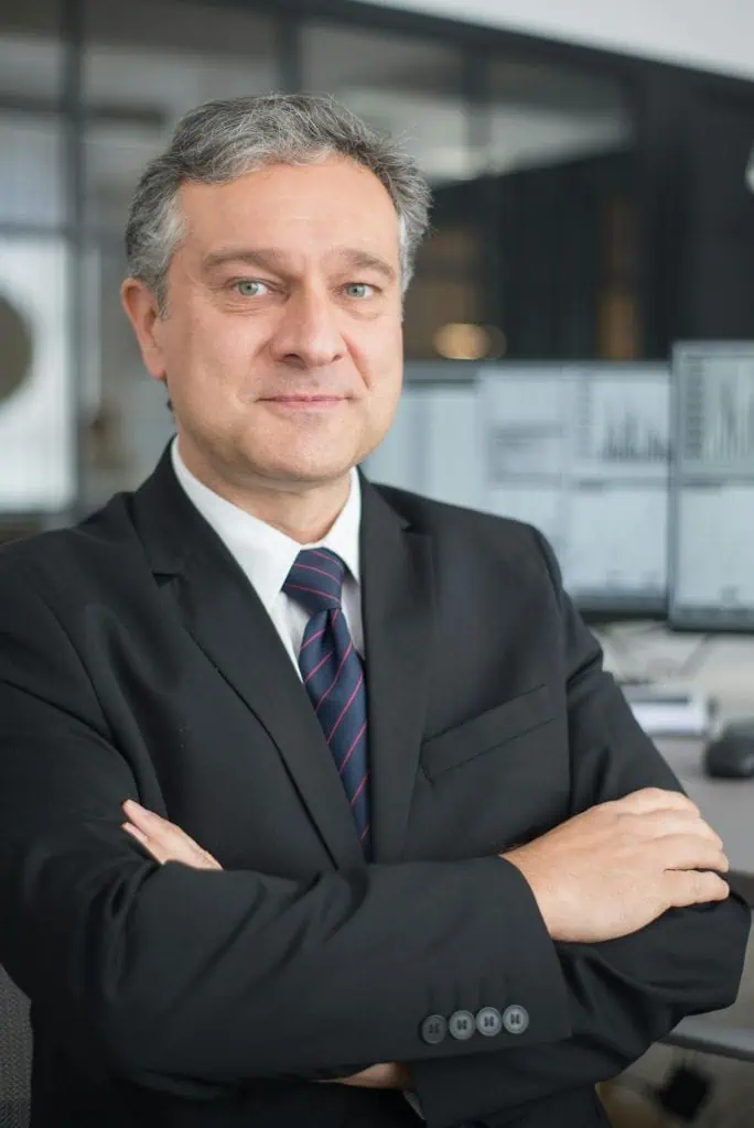 interim CEO in suit standing in modern office