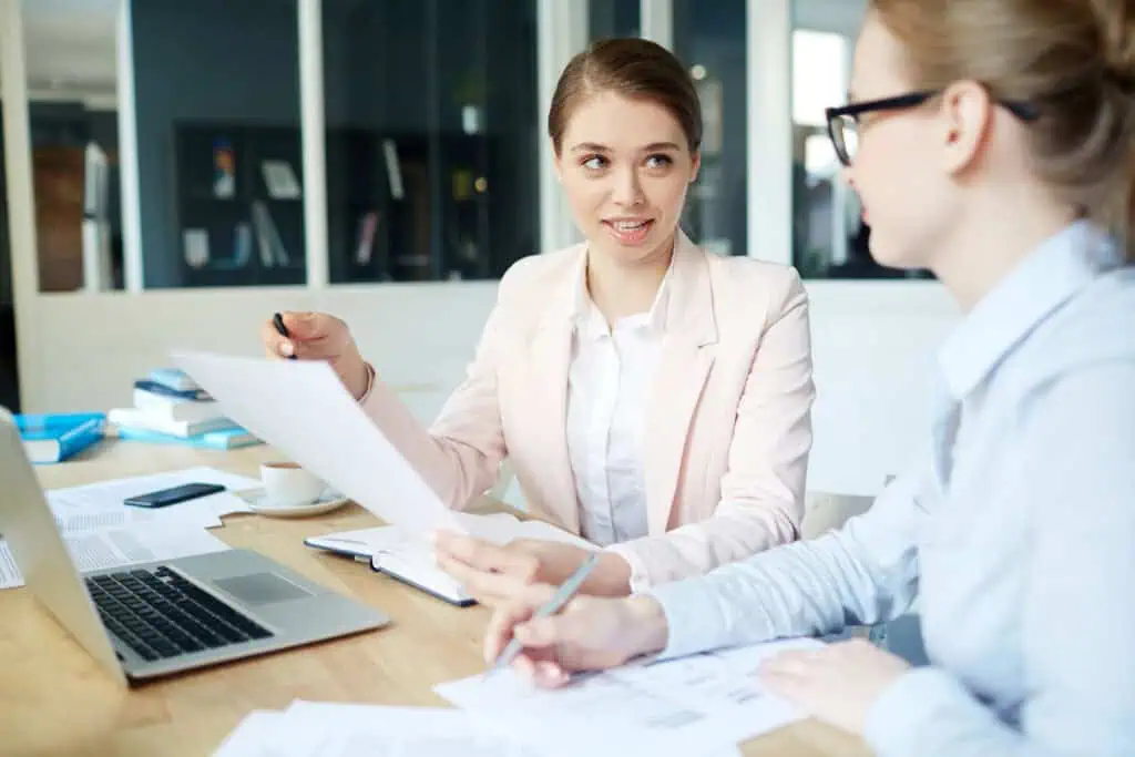 Two female interim payroll specialists working together