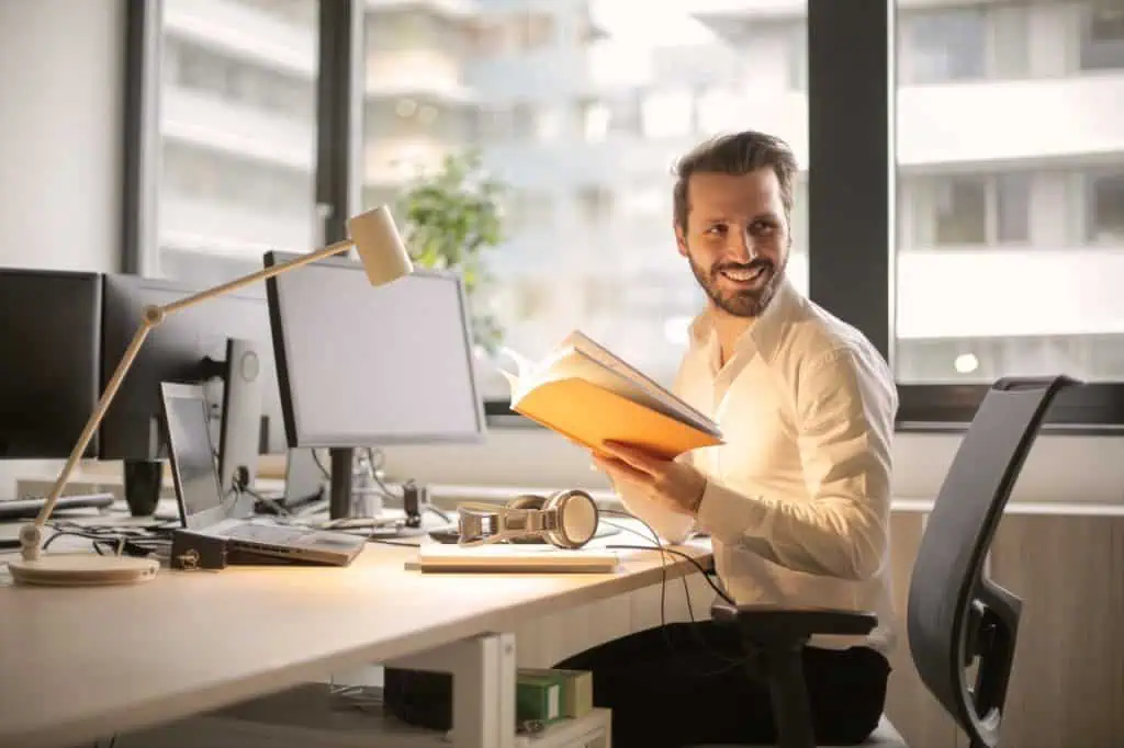 Launch manager sits at his table in office